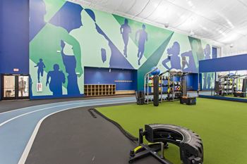A workout room with a treadmill and other equipment